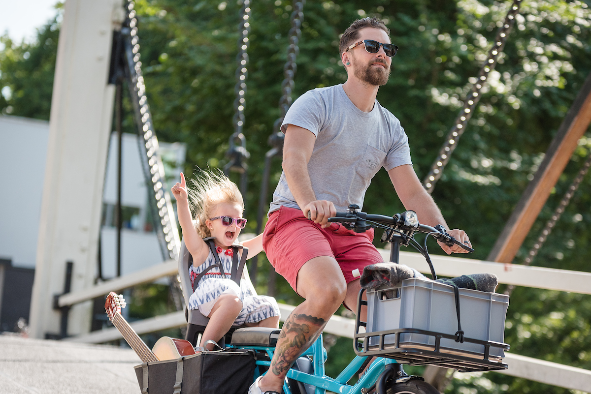 Dad and kid enjoying a ride on Tern GSD cargo ebike