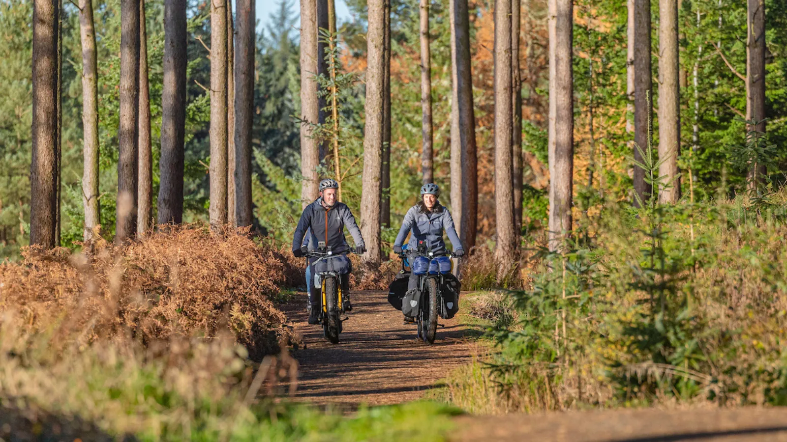A family of three riding 2 Tern Orox adventure e-cargo bikes